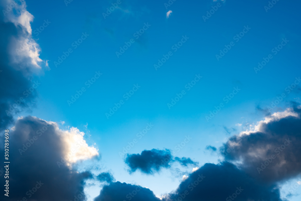 Naklejka premium Blue sky with black clouds. Blue sky with white clouds