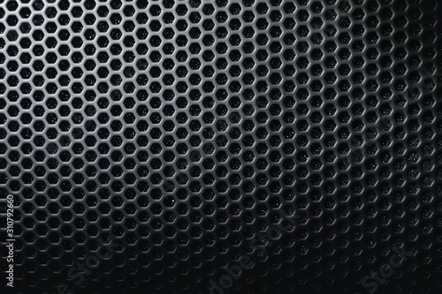 Hexagon mesh grill metal shading with holes texture background, geometric pattern, steel materials of speaker cover in black and white tone