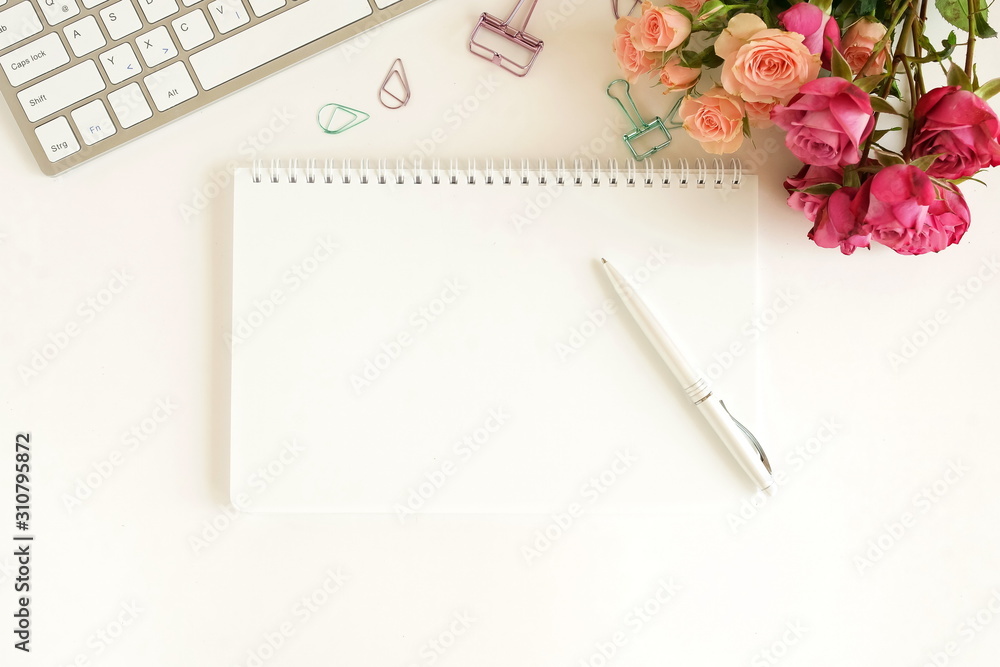 Female workspace with laptop, beautiful pink roses flowers in a vase, gift box, accessories, notebook mock up, glasses. flat lay top view women's office desk on white background selective focus. Female workspace with laptop, beautiful pink roses flowers in a vase, gift box, accessories, notebook mock up, glasses. flat lay top view women's office desk on white background selective focus.