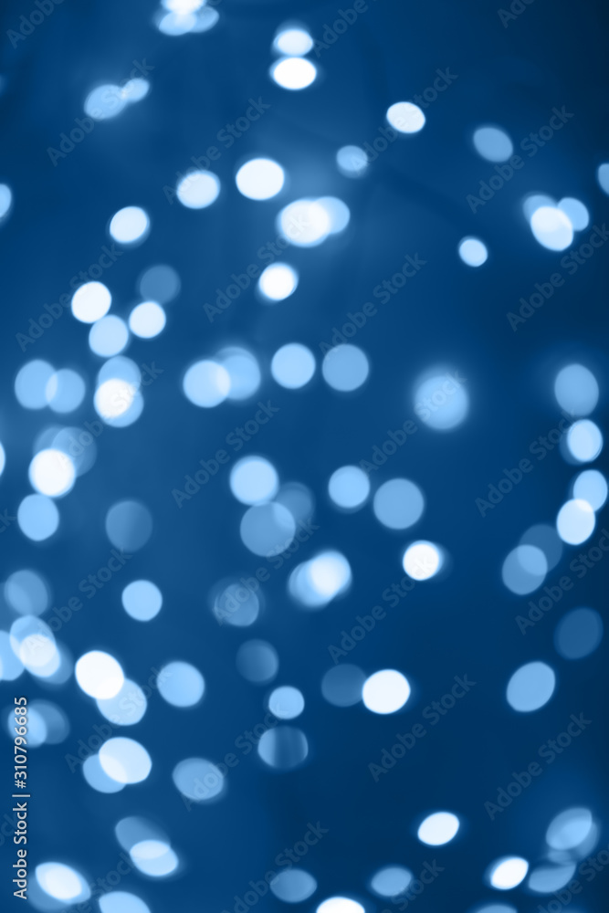 Black background with classic blue bokeh lights. Holiday, Christmas and New Year background. Horizontal, perfect for layering