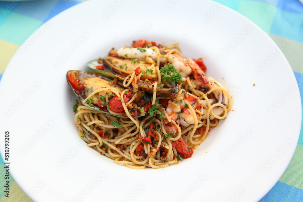 Spicy seafood spaghetti on white plate Spicy seafood spaghetti on white plate
