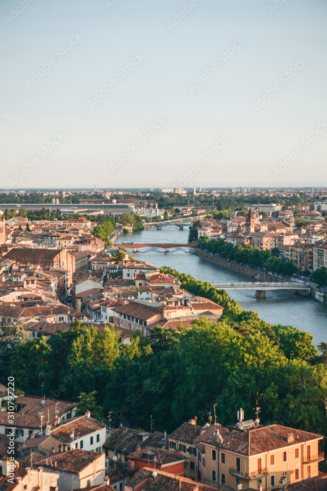 Beautiful aerial city view of traditional old architecture and river bridges in Verona in Italy.