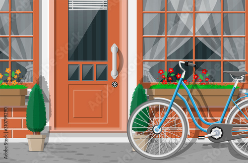Vintage house facade. Outdoor city street view. Brick building with entrance door, window with flowers, trees and bicycle. Vector illustration in flat style