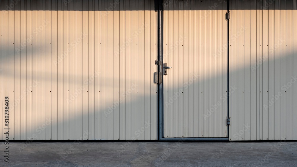 Sunlight and shadow on surface of white steel door and metal sheet wall  background on cement floor in exterior architecture concept Stock Photo |  Adobe Stock