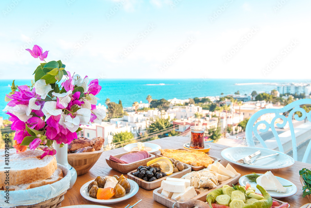 Breakfast on the beach at hotel or resort by the sea in summer season. Holiday and vacation breakfast image.Traditional Turkish or Greek breakfast at bodrum town beach in Turkey or Greece