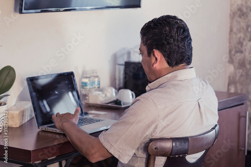 middle aged latin man working, business concept