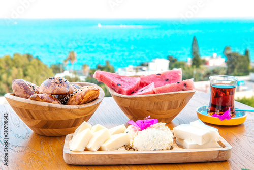Fototapeta Naklejka Na Ścianę i Meble -  Breakfast on the beach at hotel or resort by the sea in summer season. Holiday and vacation breakfast image.Traditional Turkish or Greek breakfast at bodrum town beach in Turkey or Greece