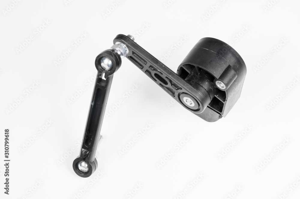 New ground clearance sensor with plastic traction on a gray background. Accessories for cars with automatic suspension height adjustment New ground clearance sensor with plastic traction on a gray background. Accessories for cars with automatic suspension height adjustment