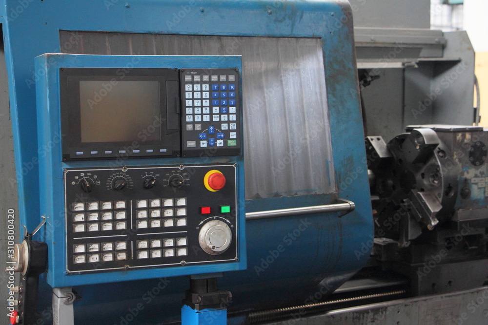 Control panel of digital CNC metal-removal turning lathe machine tool in Soviet Machine tool factory workshop