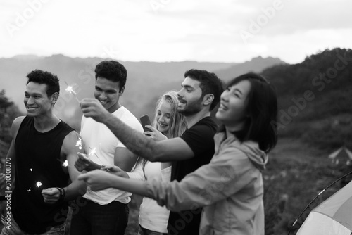 Group of diversity friends with sparklers and enjoying together at outdoor,Happy new year concept,Black and white toned