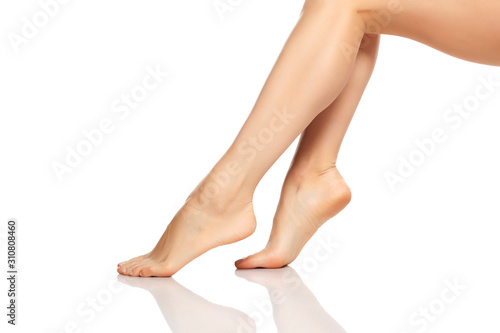 beautifully groomed female legs on a white background © vladimirfloyd