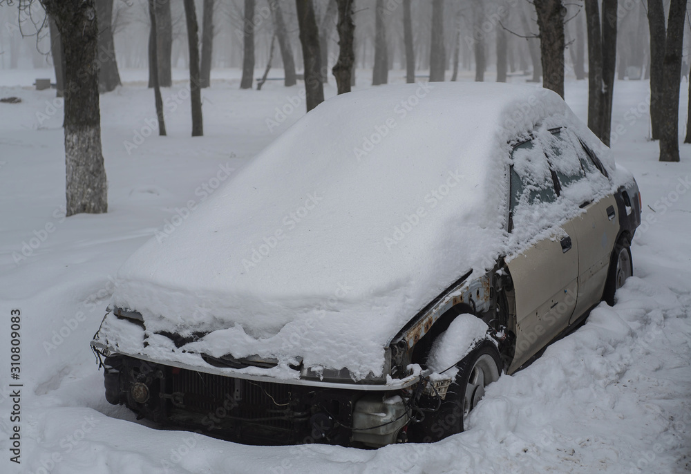 Old faulty car in the snow.