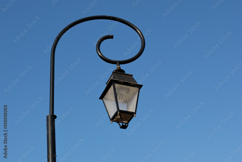 old street lamp on background of blue sky