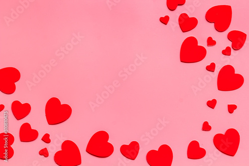Valentine's Day design. Red hearts frame on pink background top-down copy space