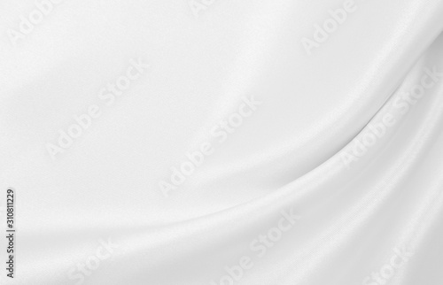 Smooth elegant white silk or satin luxury cloth texture as wedding background. Luxurious background design