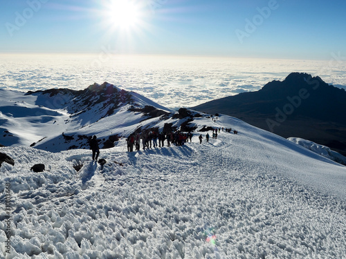 hikers on the ridge ascend mount kilimanjaro the tallest peak in africa. photo