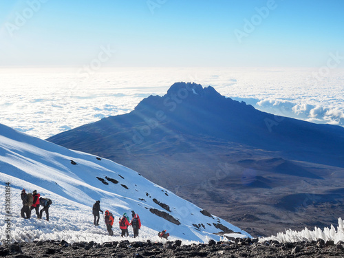 hikers on the ridge ascend mount kilimanjaro the tallest peak in africa.