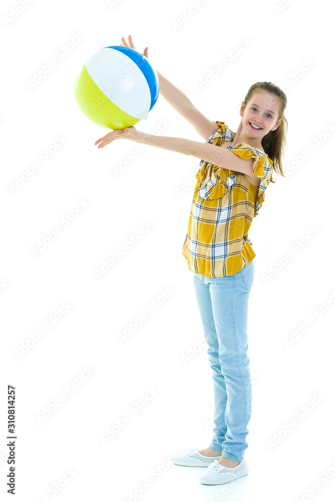 Fototapeta premium Little girl is playing with a ball.The concept of children's spo