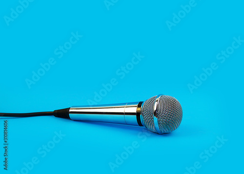 Microphone for karaoke on a blue background.