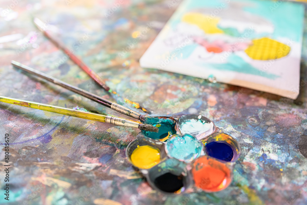 Closeup,artistic tools on colourful table,drawing and palette, paintbrush to painting watercolor on canvas,learning,activity and development of children,creative ideas,education, art concept Closeup,artistic tools on colourful table,drawing and palette, paintbrush to painting watercolor on canvas,learning,activity and development of children,creative ideas,education, art concept