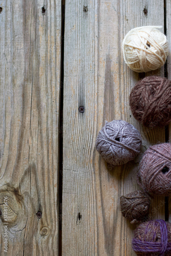 yarn balls on wooden background. a wooden background with yarn balls with copy space for design stylish yarn balls on wooden background. a wooden background with yarn balls with copy space for design stylish