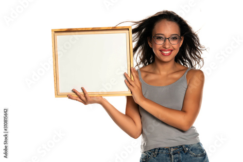 Happy dark skinned woman holding empty whiteboard on white background
