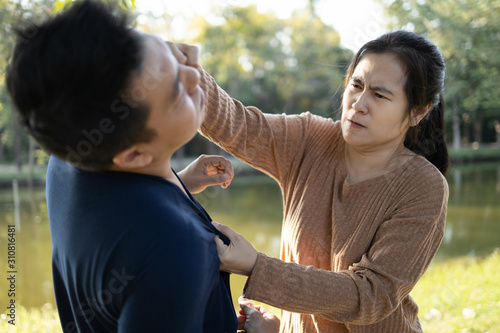 Asian woman punching on the face of man,strong punch,power in girl,angry wife loses patience,being bullied with her husband’s bad behavior,she therefore resisted and fought,life problems,violence