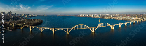 Aerial panoramic view on old arch railway Merefo-Kherson bridge across the Dnieper river in Dnepropetrovsk, Ukraine