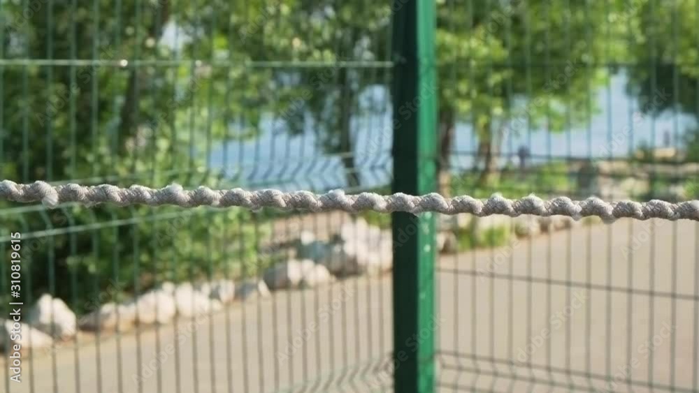 fence with rope on the background of the river fence with rope on the background of the river