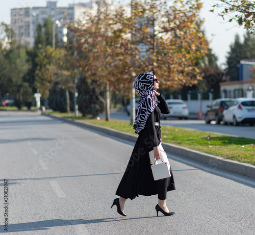 modern young muslim woman walking in the city