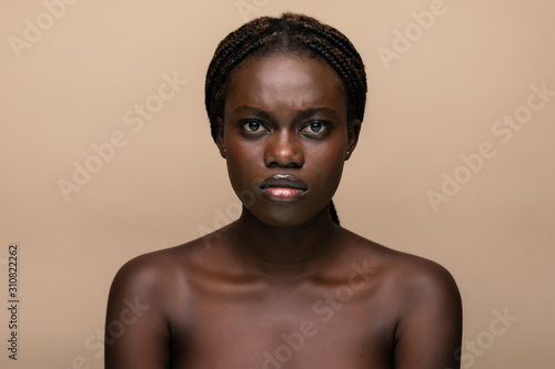 Portrait of a young beautiful african woman isolated over white background
