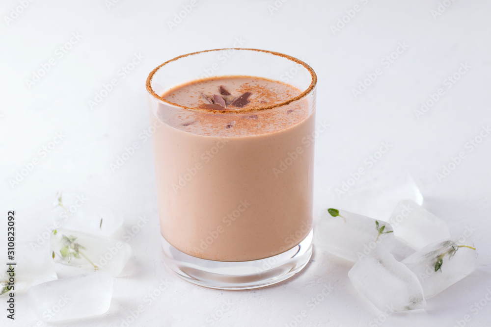 Lassi chocolate indian traditional drink next to ice cubes Lassi chocolate indian traditional drink next to ice cubes