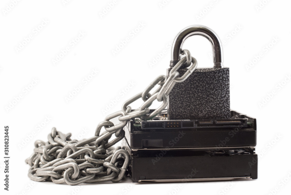 Hard disk, chain and padlock on a white background. The lock is locked. Hard disk, chain and padlock on a white background. The lock is locked.