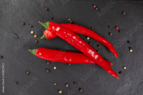 red chili peppers on a black chopping Board