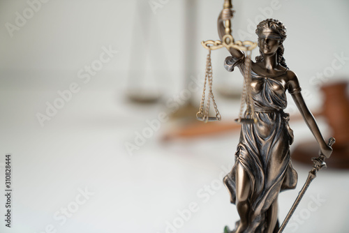 Law symbol composition. Themis statue and scale of justice on off-white background.