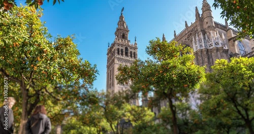 Timelapse of the Giralda Tower with blue sky and clouds passing behind. The Giralda Tower is in Seville, Andalusia, Spain. 4K, UHD, ultra HD resolution.