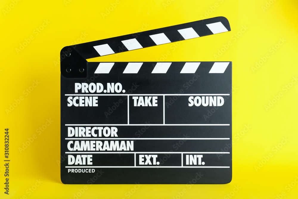 Clapper board on yellow background. Cinema production
