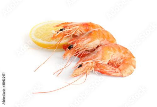 Delicious cooked shrimps and lemon isolated on white