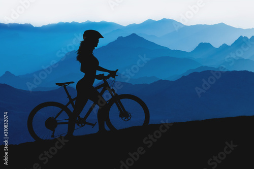 Fototapeta Naklejka Na Ścianę i Meble -  Conquering mountain peaks by cyclist in shorts and jersey on a modern carbon hardtail bike with an air suspension fork . Beautiful view from the mountain. Panoramic view for banner.