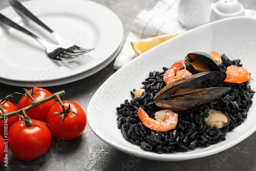 Delicious black risotto with seafood on marble table © New Africa