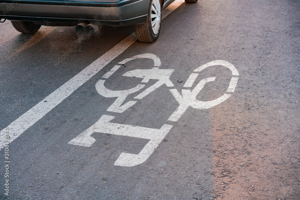 Car crossing bicycle line on the road. Traffic violation. Justice. Bike