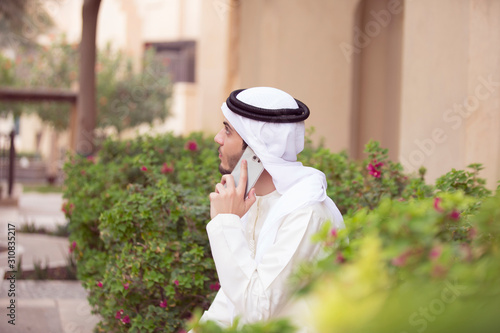 Arab young man talking with his mobile outdoor