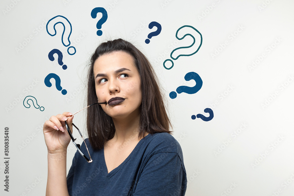 Image of excited young lady with glasses. Looking camera have an idea. Stands on a white background. Image of excited young lady with glasses. Looking camera have an idea. Stands on a white background.