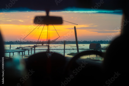 A beautiful sunset n the backwaters of Kumbalangi, Kochi (Cochin) , A view from the car parked at the docks. photo