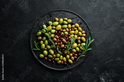 Olives in a bowl  olive oil  spices and herbs. Top view. Free space for your text.