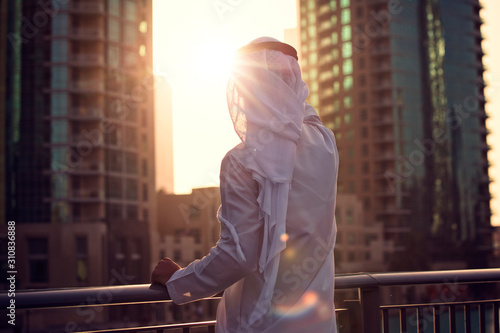 Arabic man looking to the sunrise, sunset Dubai