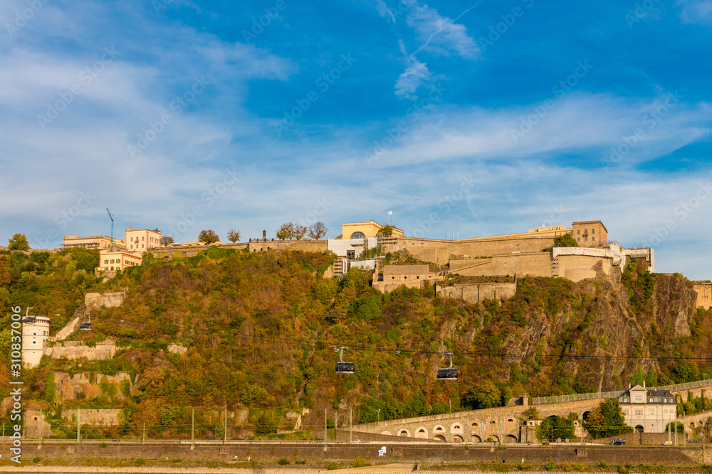 Lovely view of the Ehrenbreitstein Fortress and the cableway in Koblenz, Germany on a nice sunny autumn day with blue sky. Since 2002, Ehrenbreitstein has been part of the UNESCO World Heritage Site.