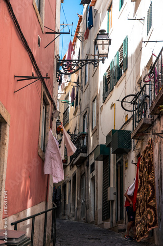 Charming narrow streets in Alfama district, Lisbon, Portugal © RowanArtCreation