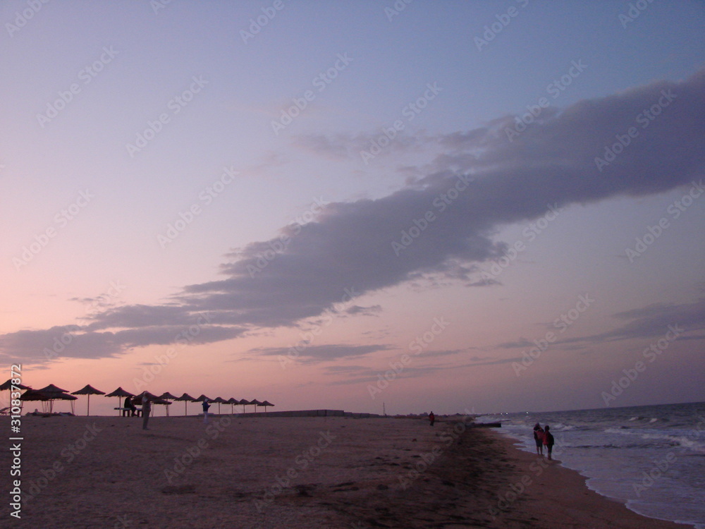 The incredible beauty of the evening sky at sunset over the sandy coast of the Azov Sea. The incredible beauty of the evening sky at sunset over the sandy coast of the Azov Sea.