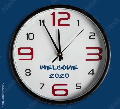 Text WELCOME 2020. Large wall clock on a classic blue background